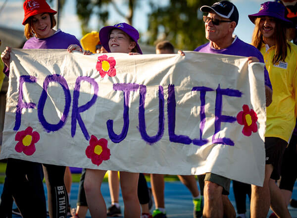 Relayers carrying a home-made banner with the words 'For Julie' Relayers carrying a home-made banner with the words 'For Julie'